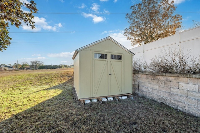 view of outdoor structure featuring a lawn