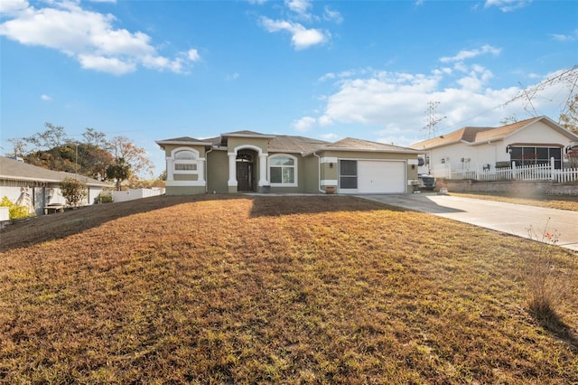 view of front of property featuring a front yard and a garage