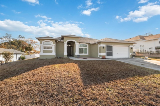 view of front of house featuring a front yard and a garage