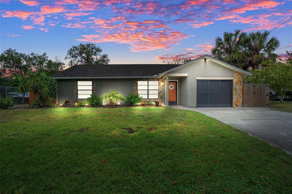 ranch-style house with a lawn and a garage