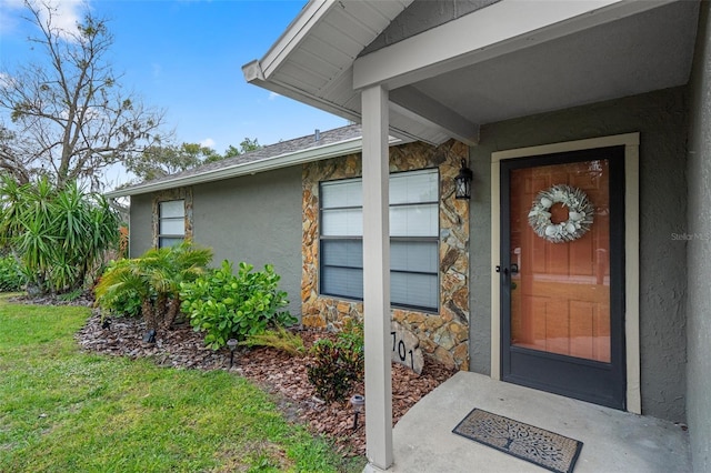 doorway to property with a yard