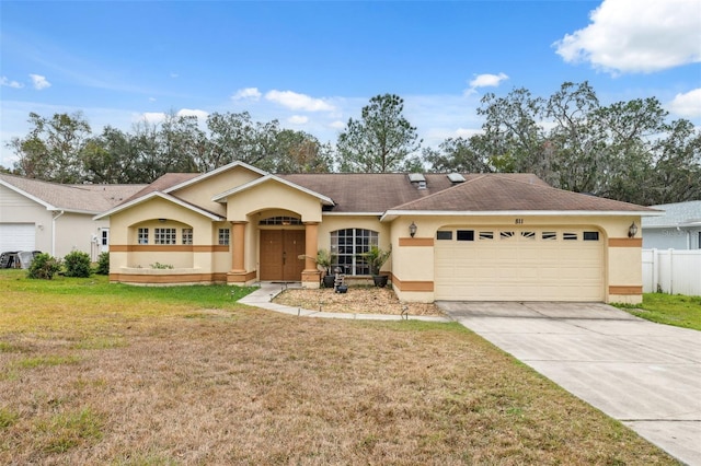 ranch-style home featuring a front lawn and a garage