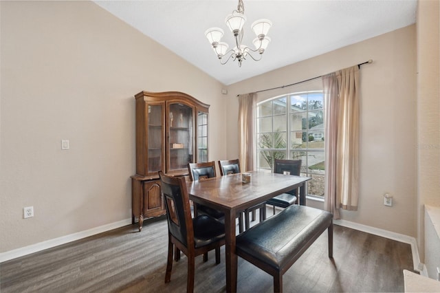 dining space with dark hardwood / wood-style floors, lofted ceiling, and a chandelier