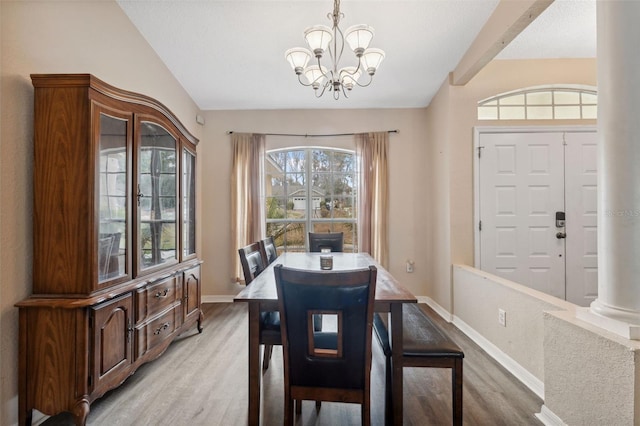 dining space featuring light hardwood / wood-style flooring and an inviting chandelier