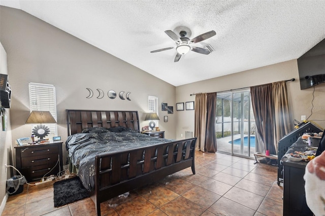 bedroom featuring a textured ceiling, access to outside, lofted ceiling, ceiling fan, and tile patterned floors