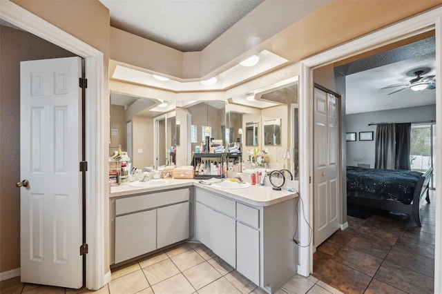 bathroom featuring a textured ceiling, ceiling fan, tile patterned floors, and vanity