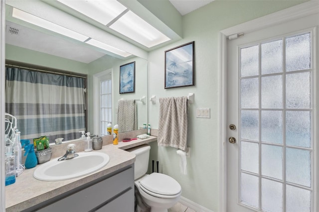 bathroom featuring toilet and vanity