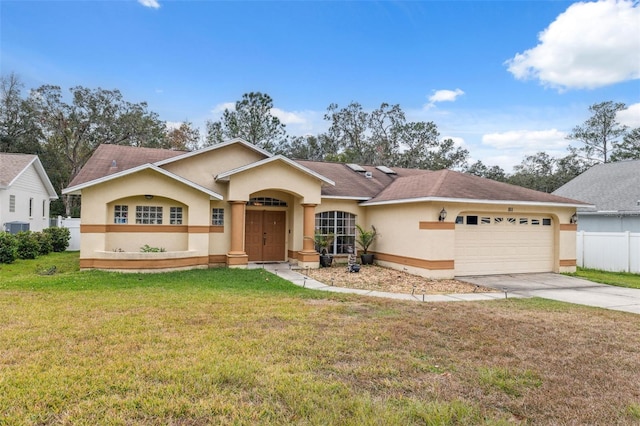 ranch-style home featuring a garage and a front yard