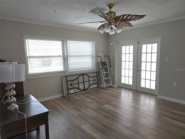 interior space with french doors, a textured ceiling, and a wealth of natural light