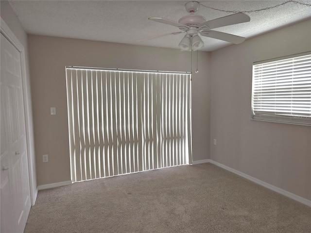 empty room with carpet flooring and ceiling fan