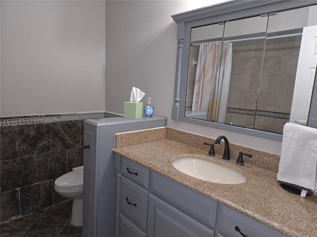 bathroom featuring vanity, tile patterned floors, a shower with curtain, toilet, and tile walls