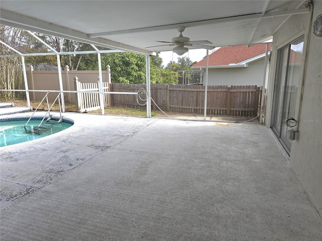 view of swimming pool with a lanai, ceiling fan, and a patio