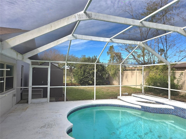 view of pool featuring a patio, glass enclosure, and a hot tub