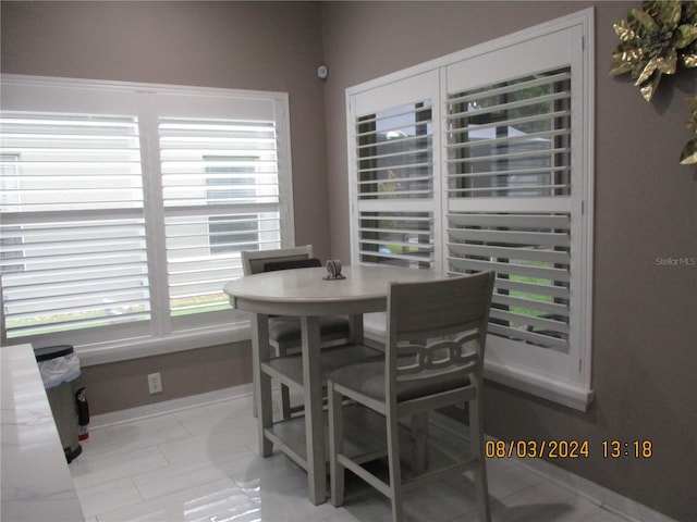 dining area featuring light tile patterned floors