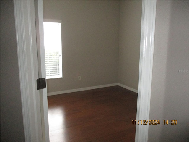 spare room with dark hardwood / wood-style floors