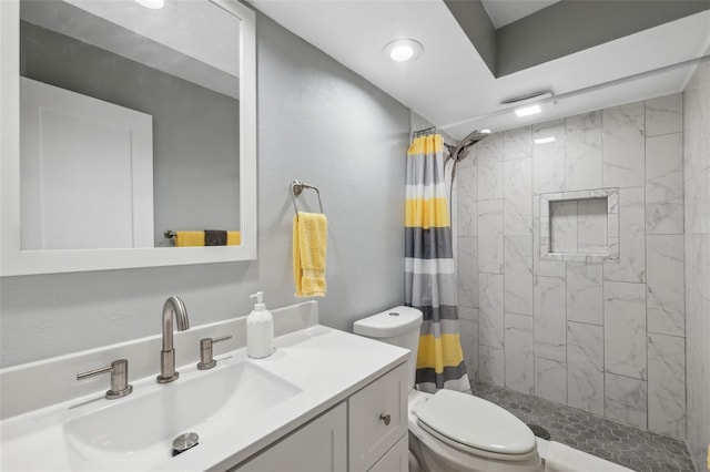 bathroom featuring a shower with curtain, vanity, and toilet