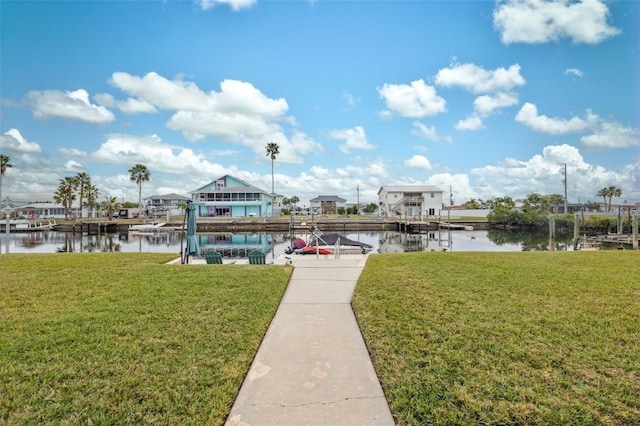 dock area featuring a lawn and a water view