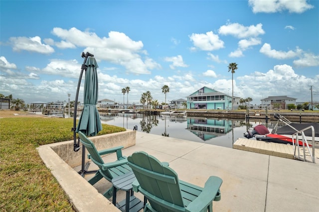 view of patio featuring a dock and a water view