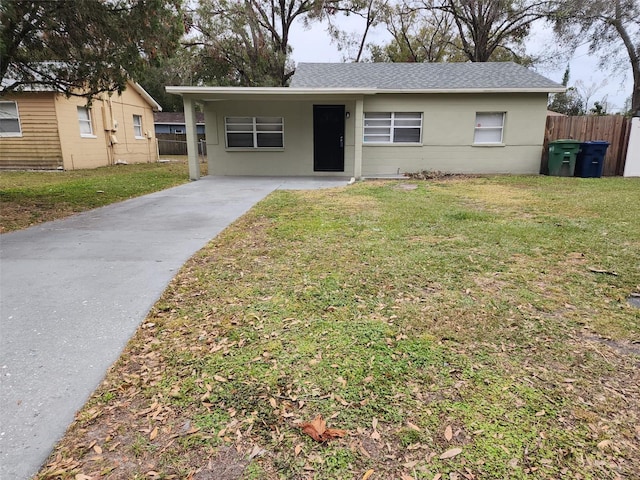 ranch-style home with a front lawn and a carport