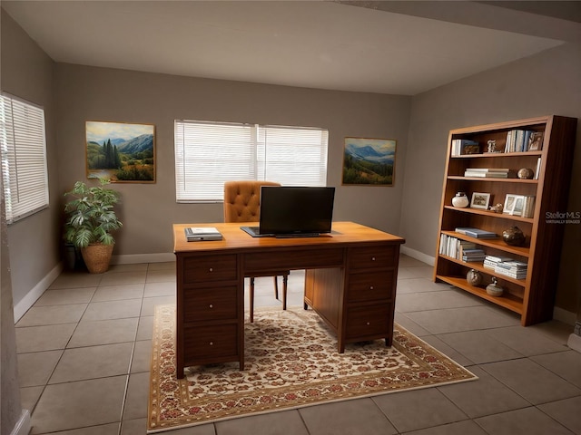 unfurnished office featuring light tile patterned floors