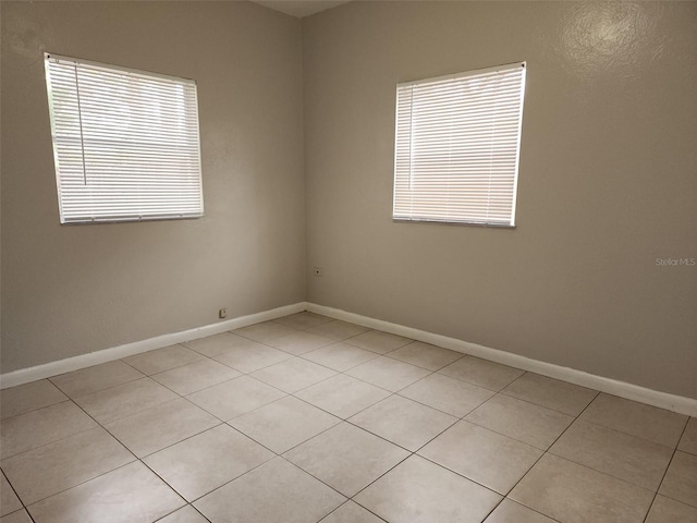 spare room featuring light tile patterned floors