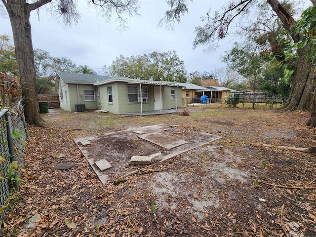 back of house with central AC