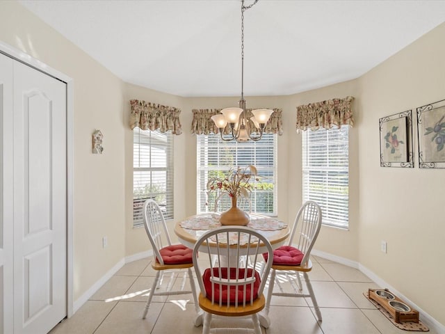 dining area featuring light tile patterned floors and a chandelier