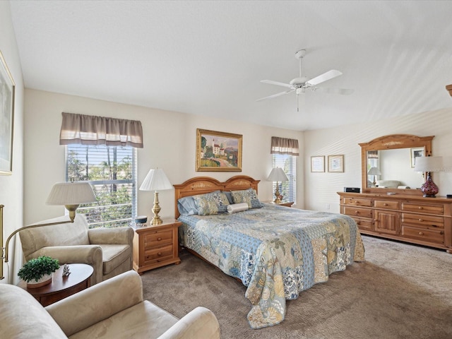 bedroom with multiple windows, lofted ceiling, ceiling fan, and carpet flooring