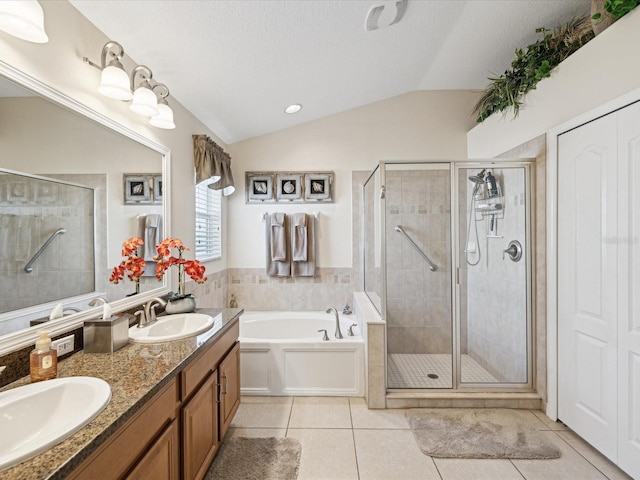 bathroom featuring vanity, vaulted ceiling, plus walk in shower, and tile patterned floors