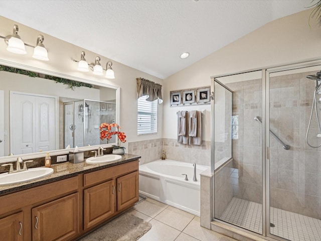 bathroom with vaulted ceiling, separate shower and tub, tile patterned floors, and vanity