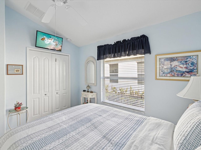 bedroom with lofted ceiling, a closet, and ceiling fan