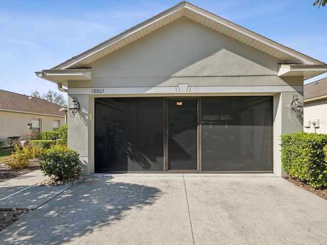 rear view of property featuring a garage