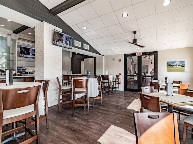 dining room featuring lofted ceiling with beams, a paneled ceiling, dark hardwood / wood-style flooring, and french doors