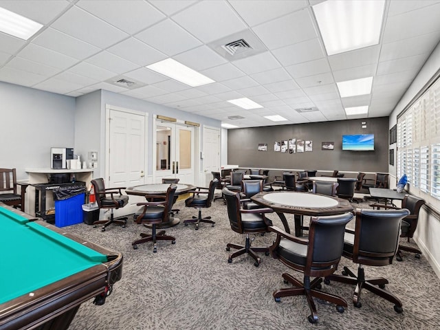 interior space featuring carpet floors and a drop ceiling