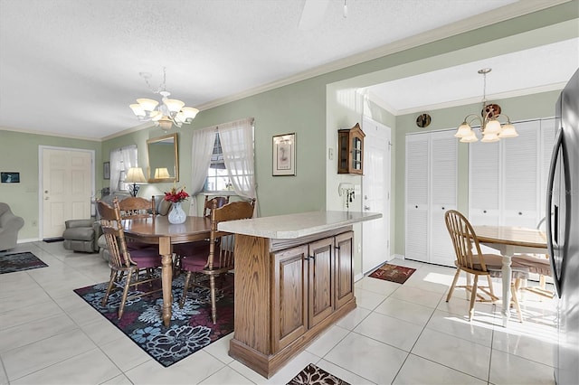 dining area featuring a textured ceiling, light tile patterned floors, crown molding, and a chandelier