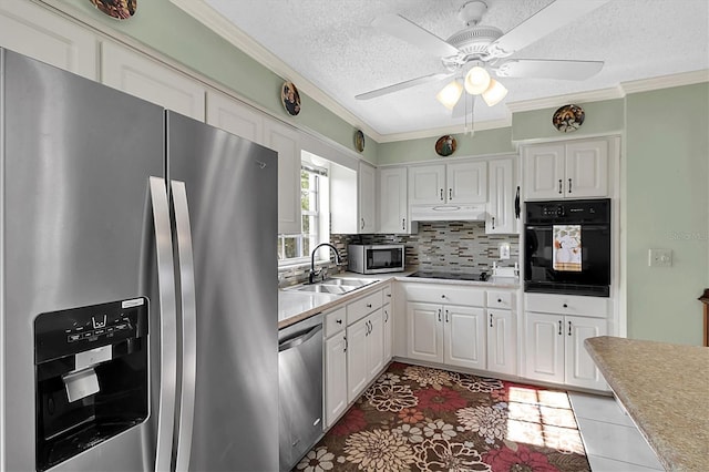 kitchen featuring sink, white cabinets, a textured ceiling, tasteful backsplash, and black appliances