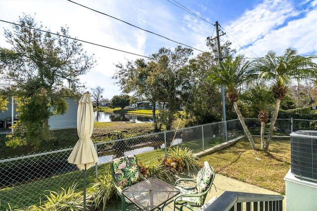 view of yard featuring a patio, cooling unit, and a water view