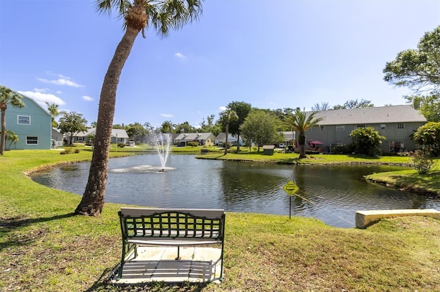 exterior space featuring a lawn and a water view