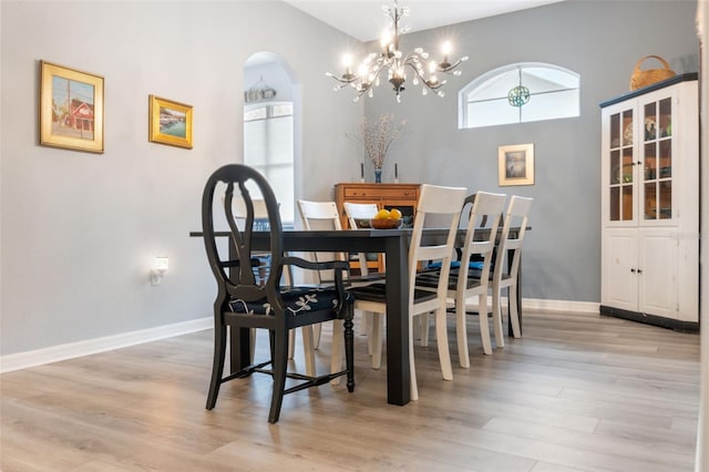 dining room with an inviting chandelier and light hardwood / wood-style flooring