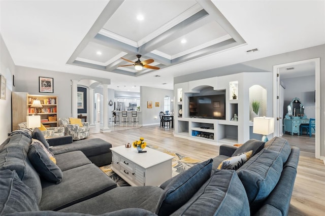 living room featuring light hardwood / wood-style floors, coffered ceiling, and built in shelves