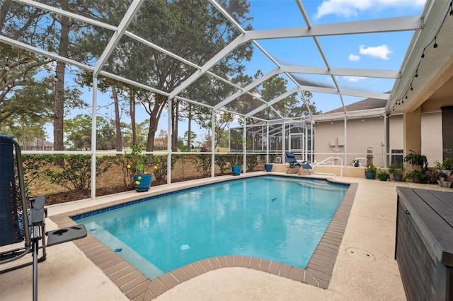 view of swimming pool featuring a patio and glass enclosure