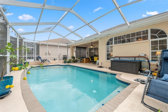 view of pool featuring a lanai, a patio, and ceiling fan