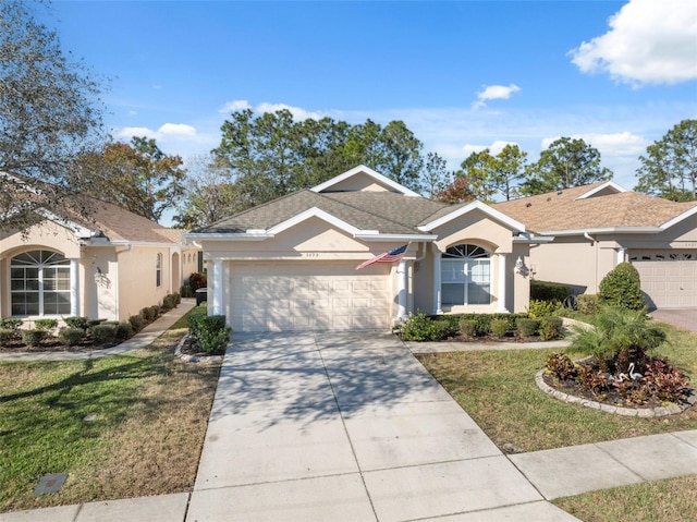 ranch-style house featuring a front lawn and a garage