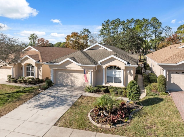 ranch-style home featuring a front lawn and a garage