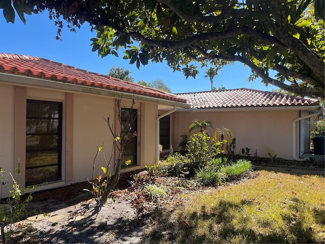 view of side of home with a lawn