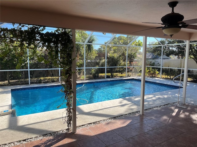 view of pool featuring a lanai, a patio area, and ceiling fan