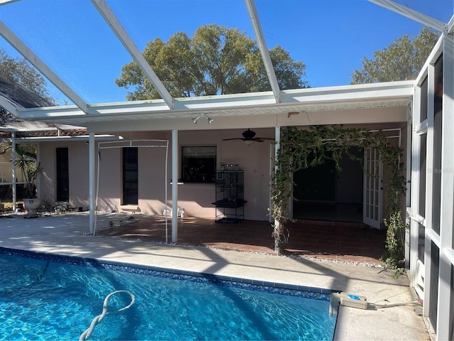 view of pool with a patio, ceiling fan, and a lanai