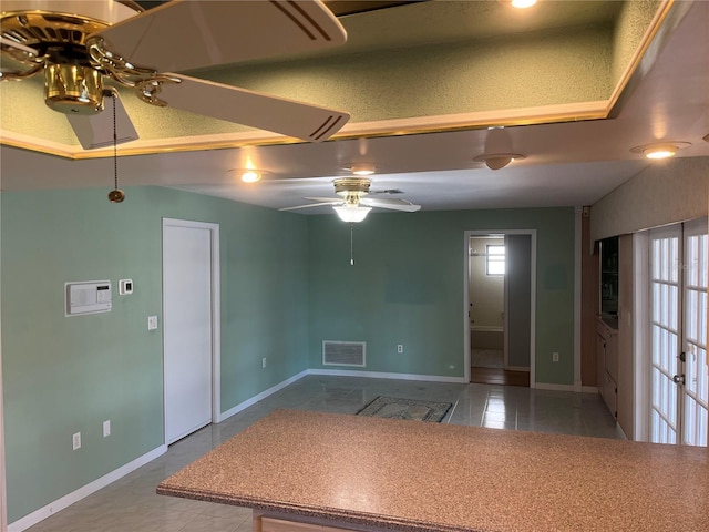 tiled empty room with ceiling fan and plenty of natural light