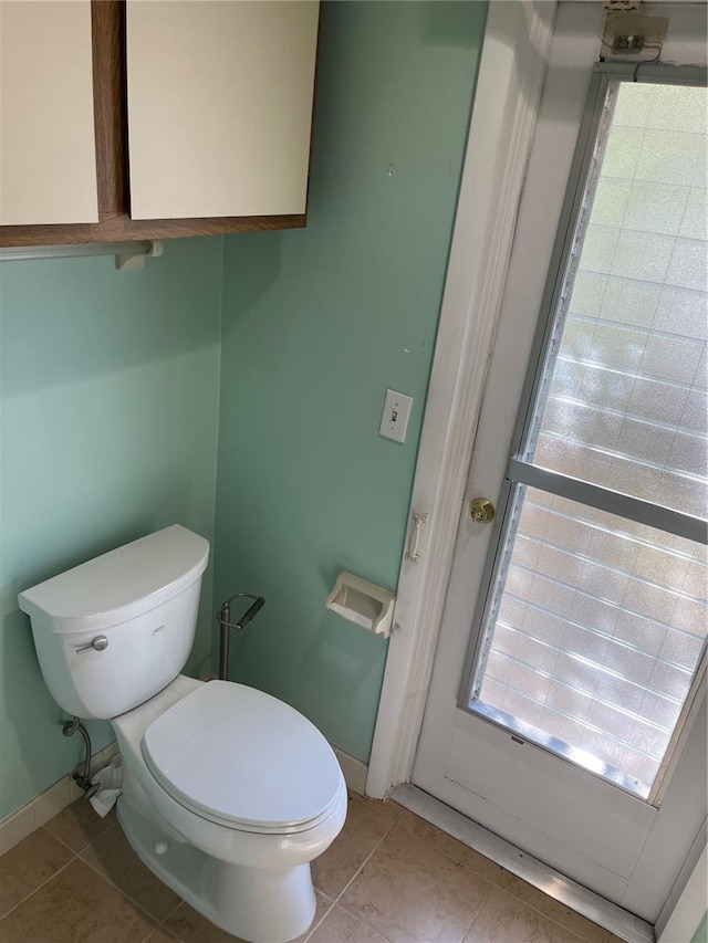 bathroom with tile patterned floors and toilet