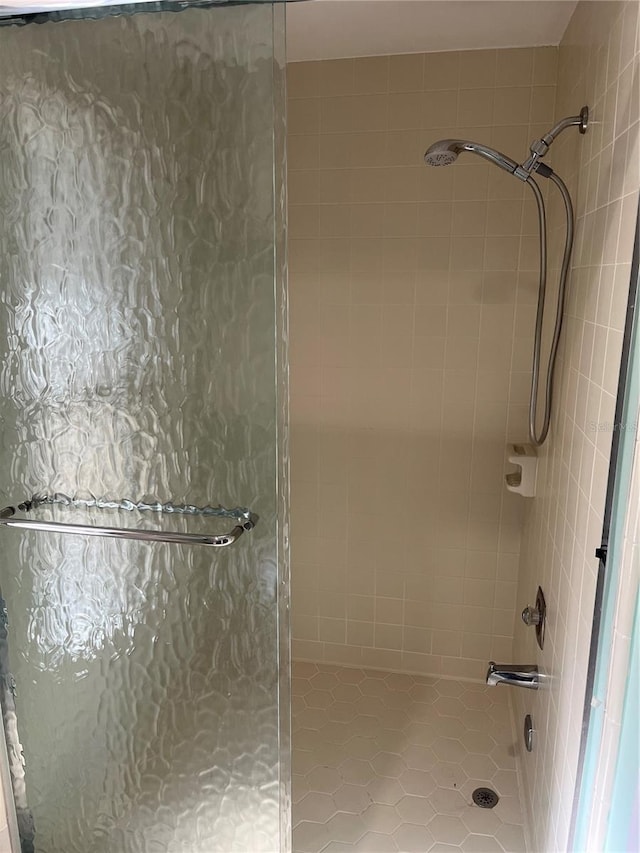 bathroom with a shower with door